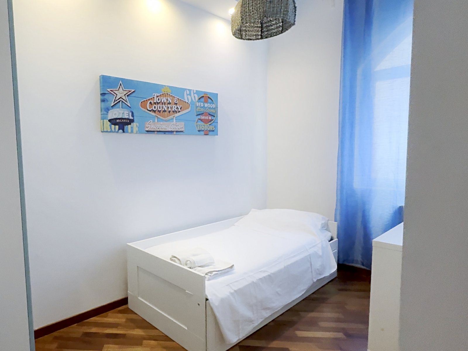 Zimmer mit Einzelbett mit Ausziehbett und blauen Vorhängen, Via Machiavelli, Triest