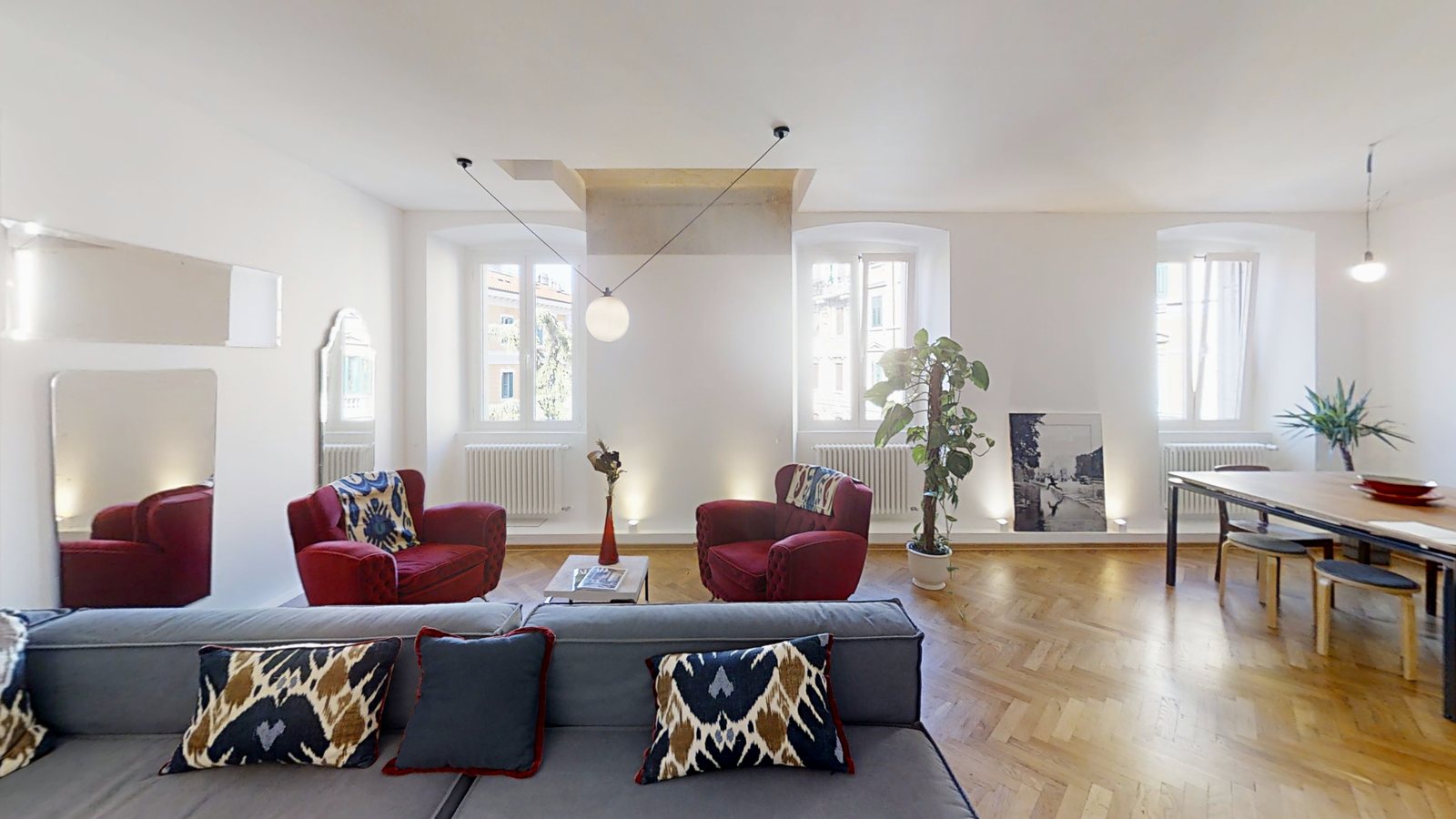 Living room with grey sofa, red velvet armchairs and tall windows, Via dei Fabbri, Trieste