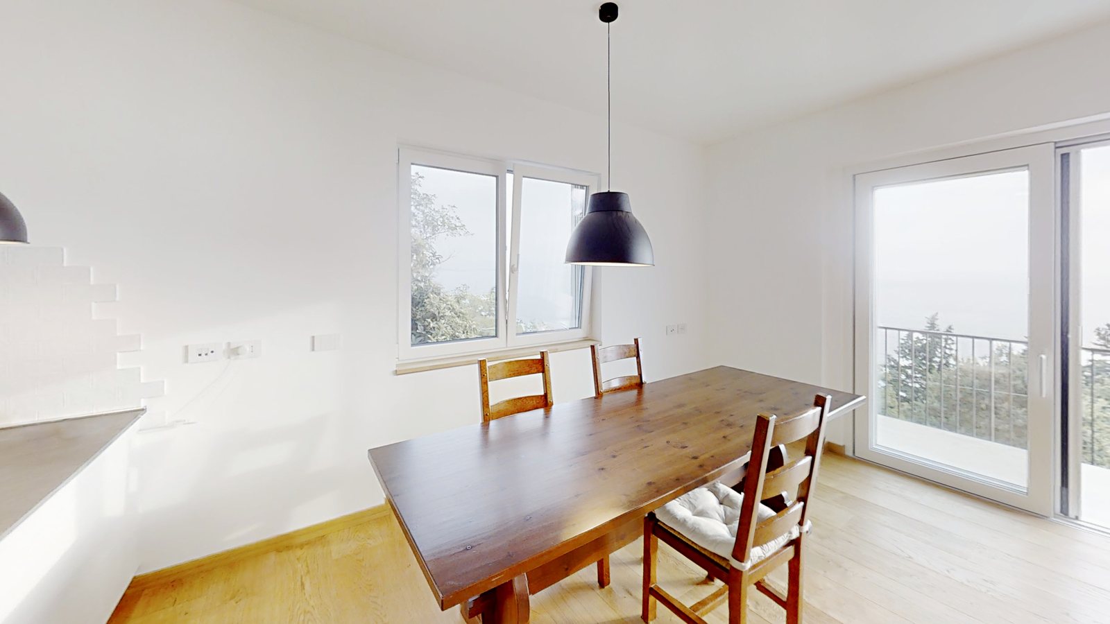 Dining area with wooden table, window and French window to the balcony, Salita di Cedassamare, Trieste