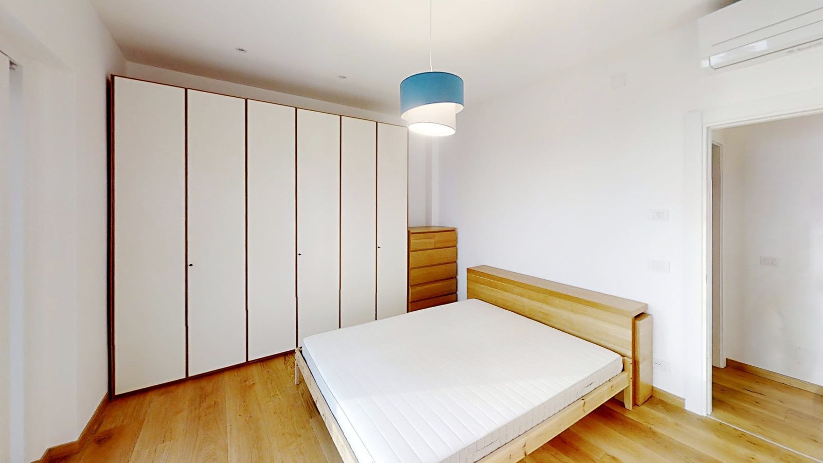 Double bedroom with six-door white wardrobe and light wooden bed, Salita di Cedassamare, Trieste
