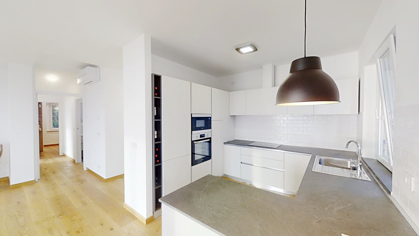 White U-shaped kitchen with grey stone worktop, built-in oven and microwave, Salita di Cedassamare, Trieste