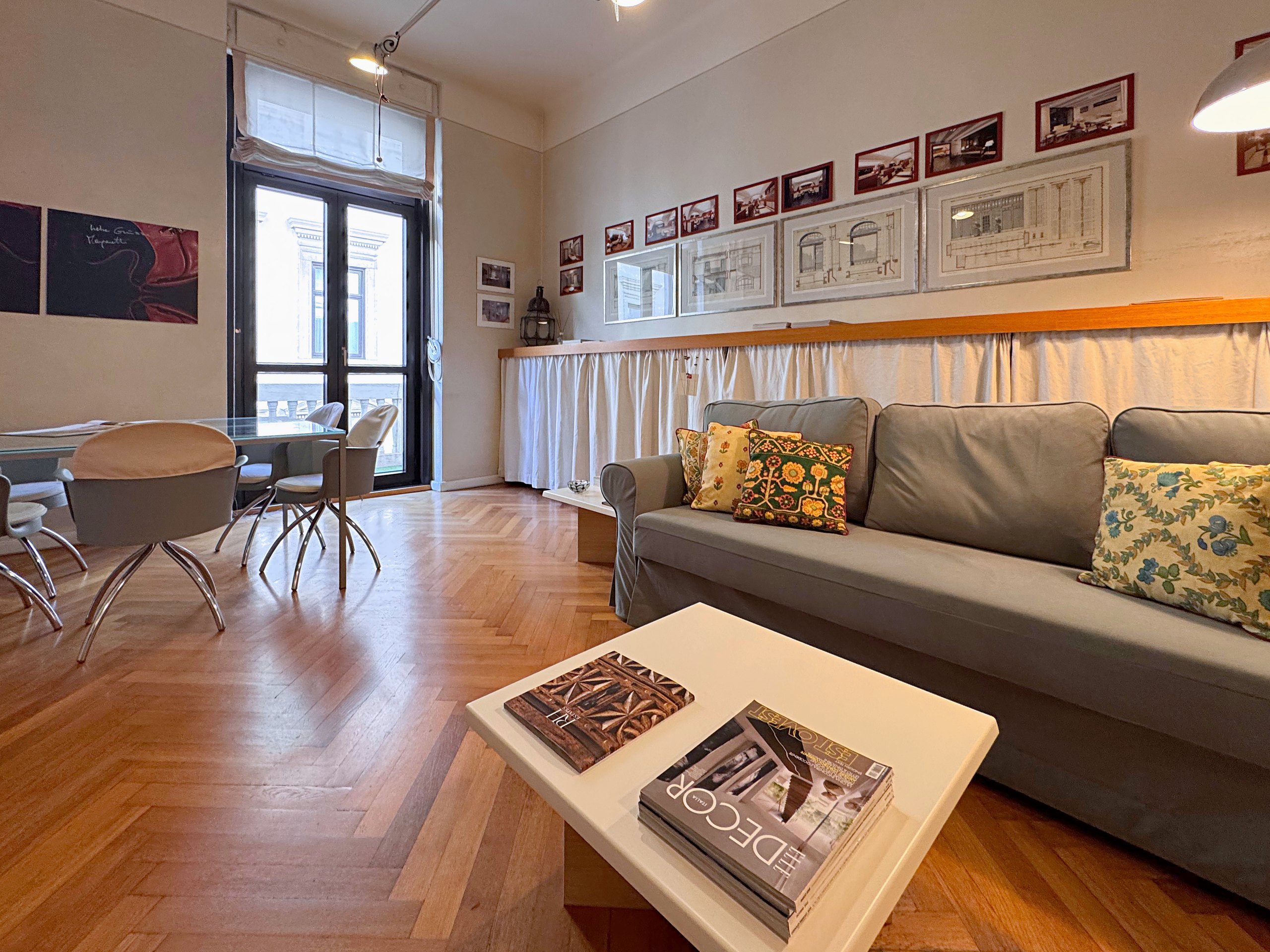 Sitting room with sofa, table by the French window and high ceilings, Via Santa Caterina, Trieste