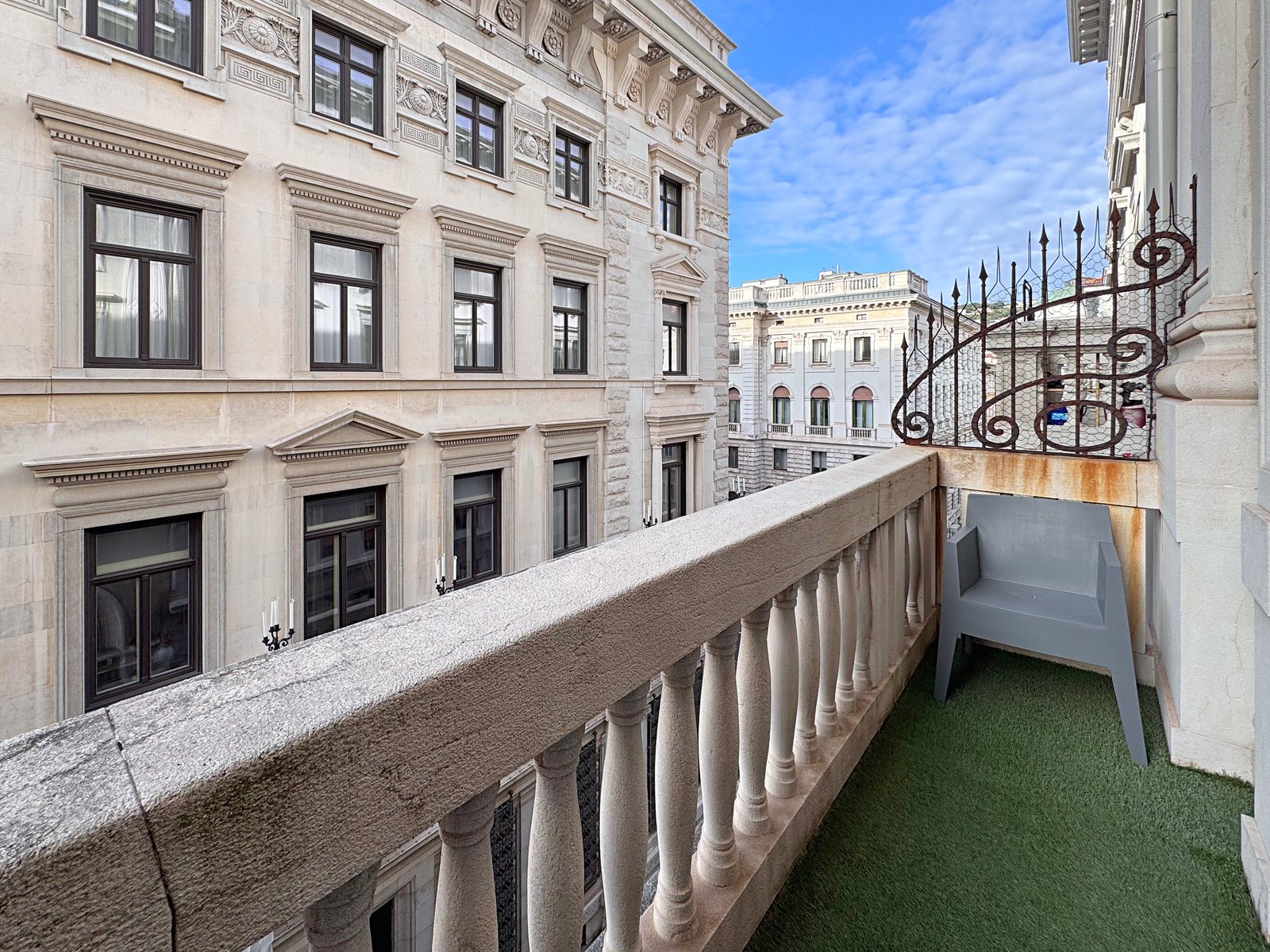 Balcony with stone balustrade facing the historic building opposite, Via Santa Caterina, Trieste
