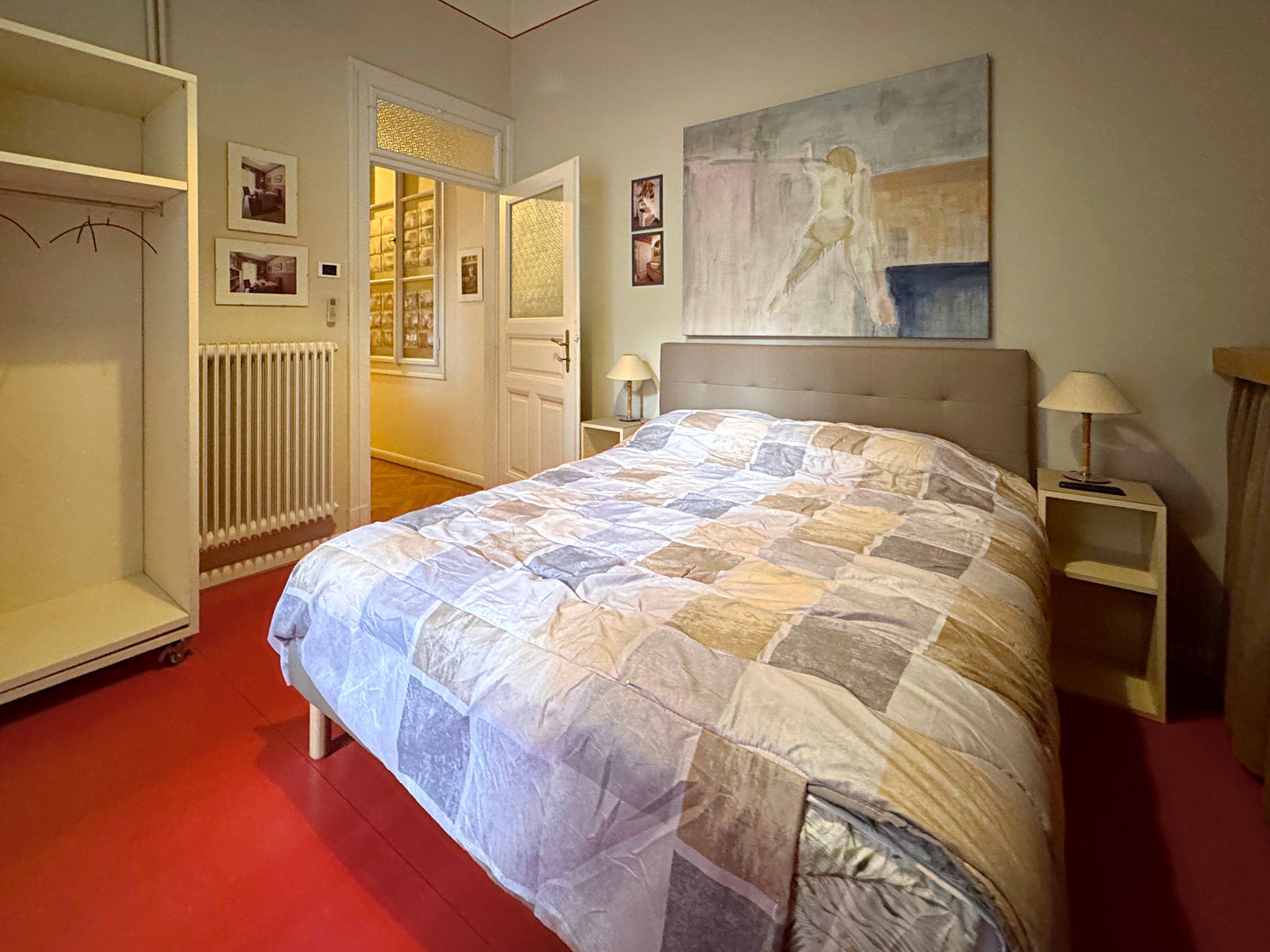 Double bedroom with open wardrobe, bedside tables and painting above the bed, Via Santa Caterina, Trieste