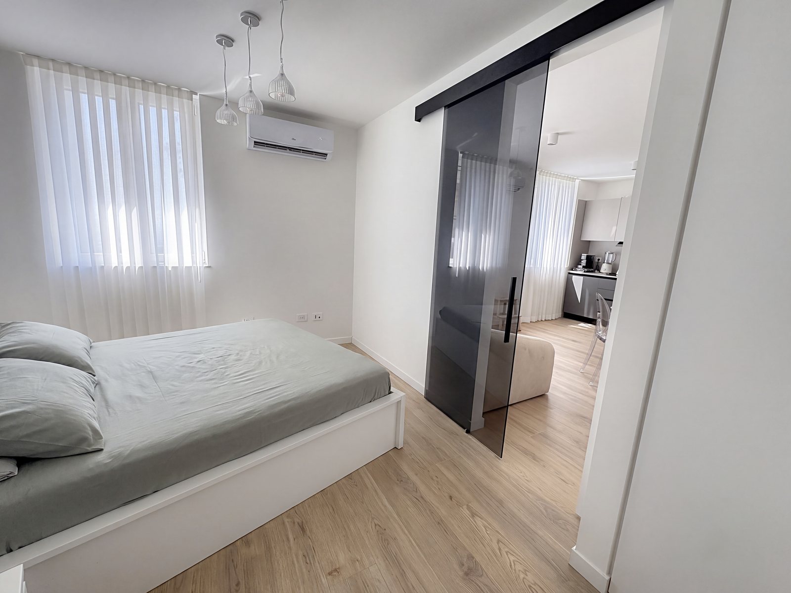 Double bedroom with window and glass sliding door to the living area, Salita di Gretta, Trieste