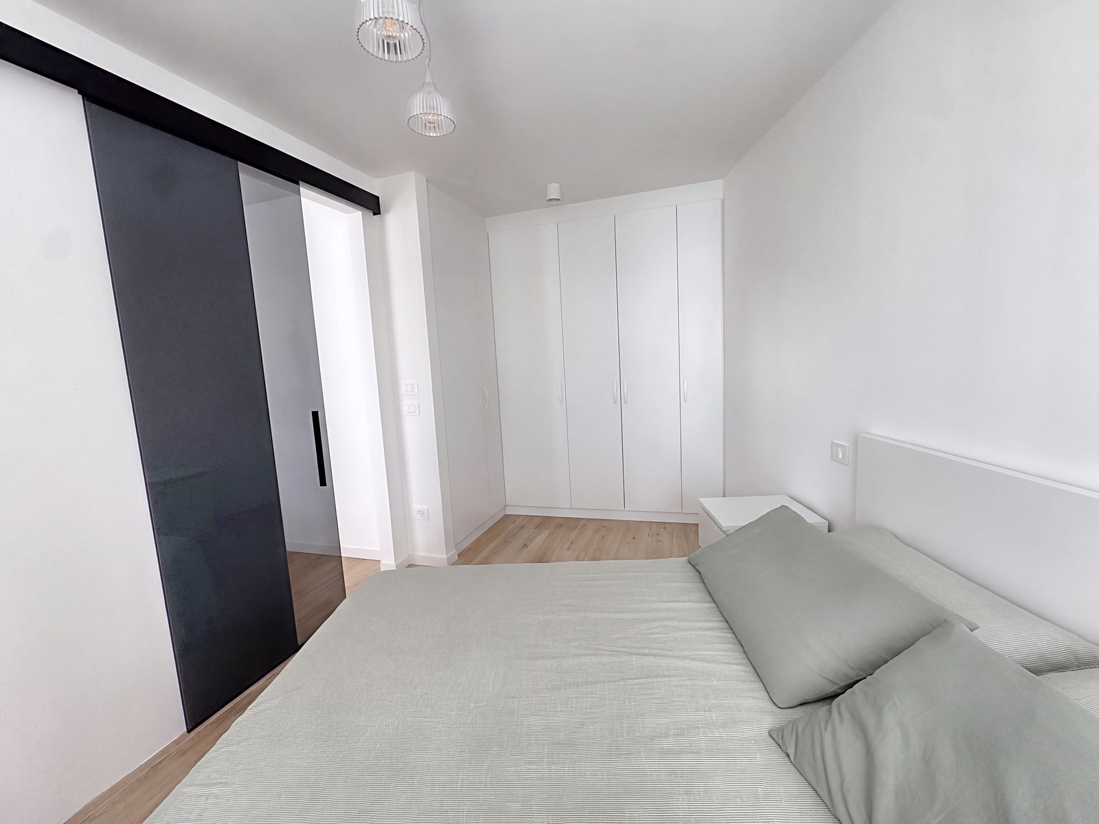 Bedroom with white built-in wardrobe and smoked-glass sliding door, Salita di Gretta, Trieste