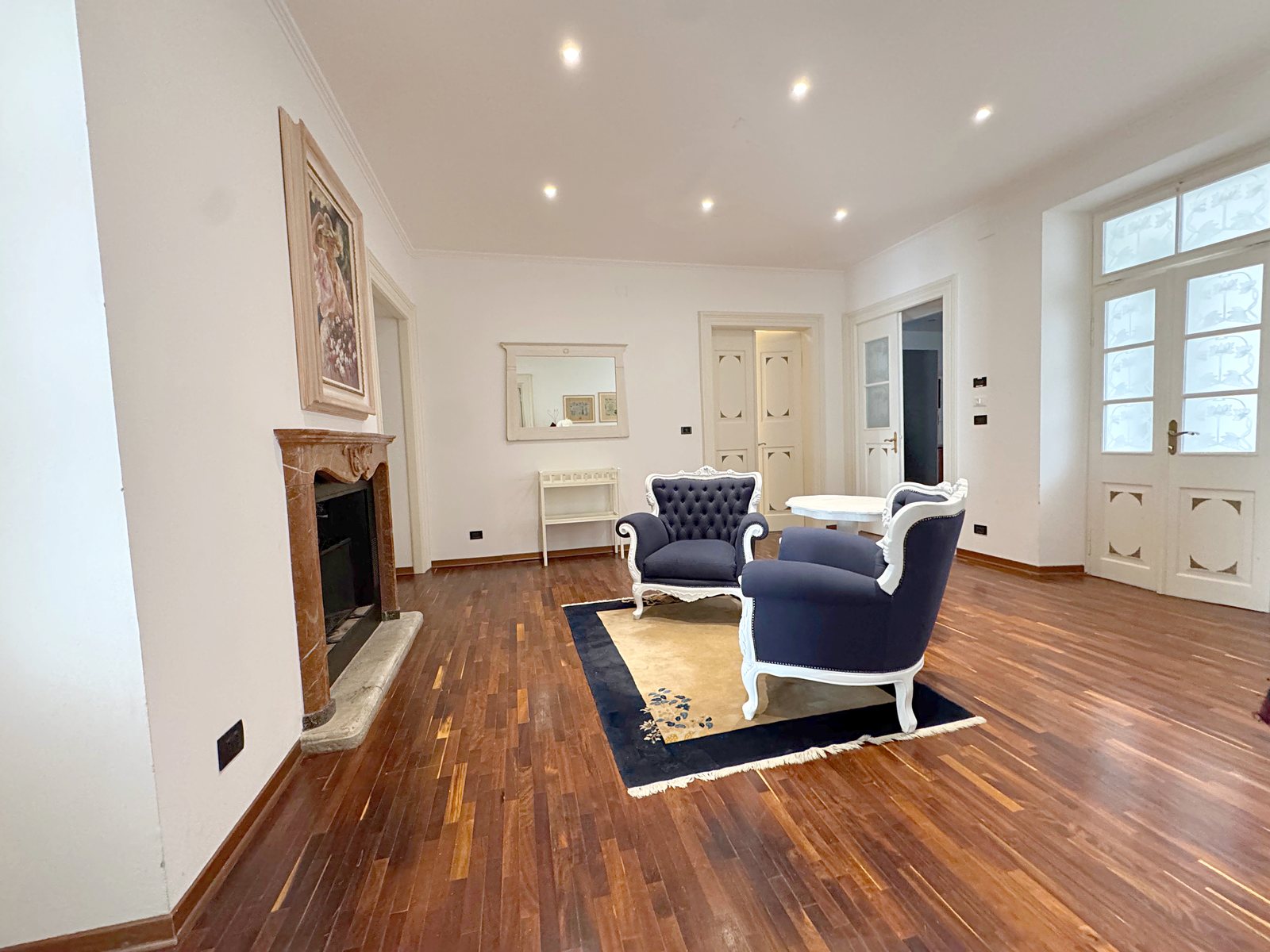 Salon z marmornim kaminom in modrimi naslanjači, stanovanje v Ulici Torre Bianca, Trst